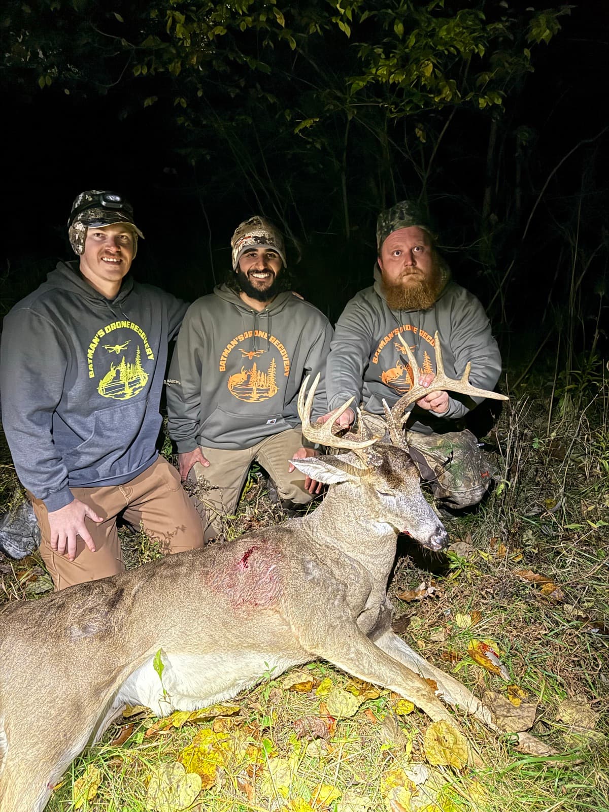 Three-man crew with a night-recovered whitetail